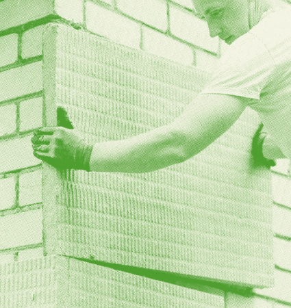 Worker installing an insulating panel in the context of energy work 